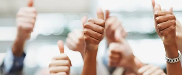 Several hands raised in a thumbs up
